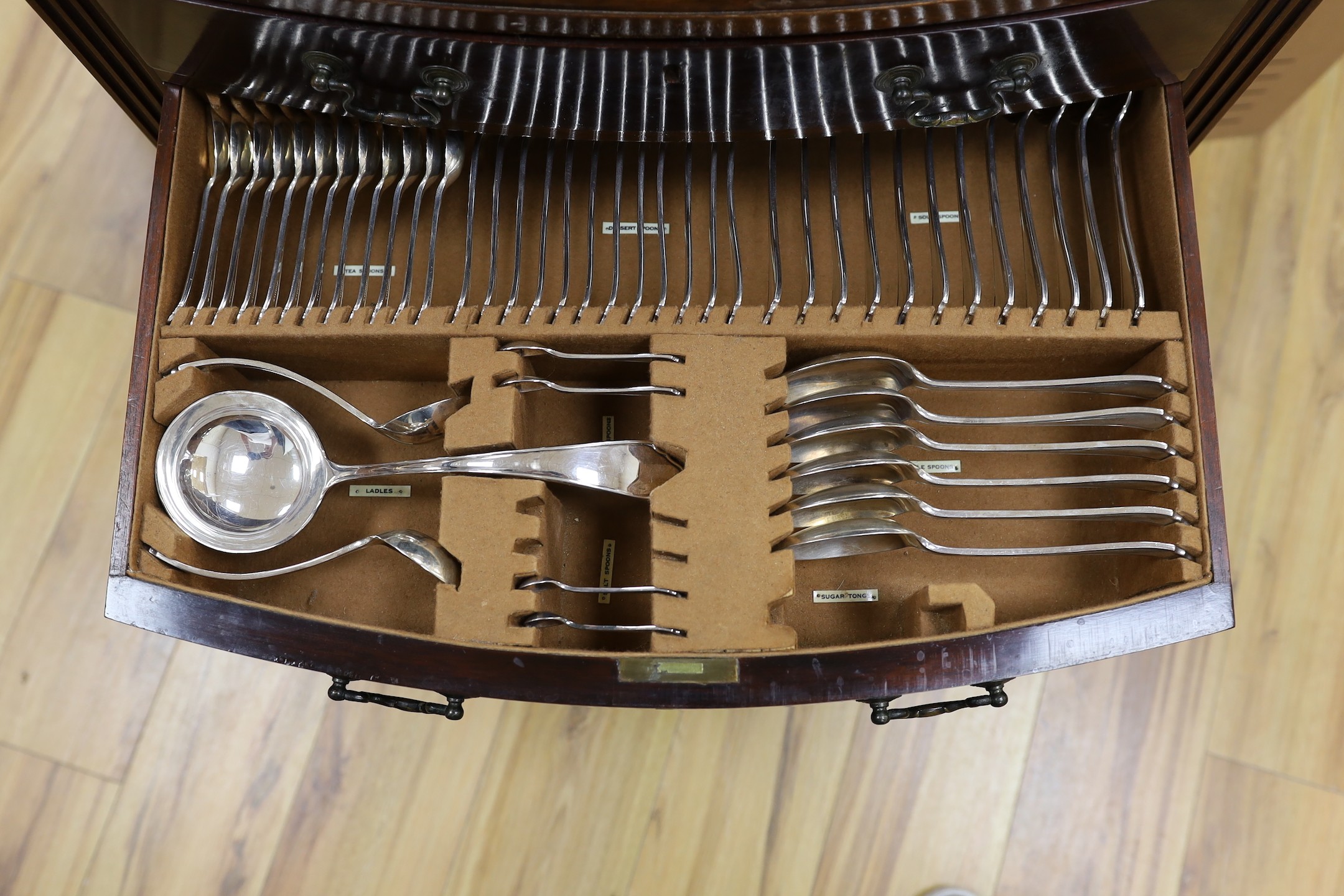 A suite of cutlery, in mahogany two drawer cabinet